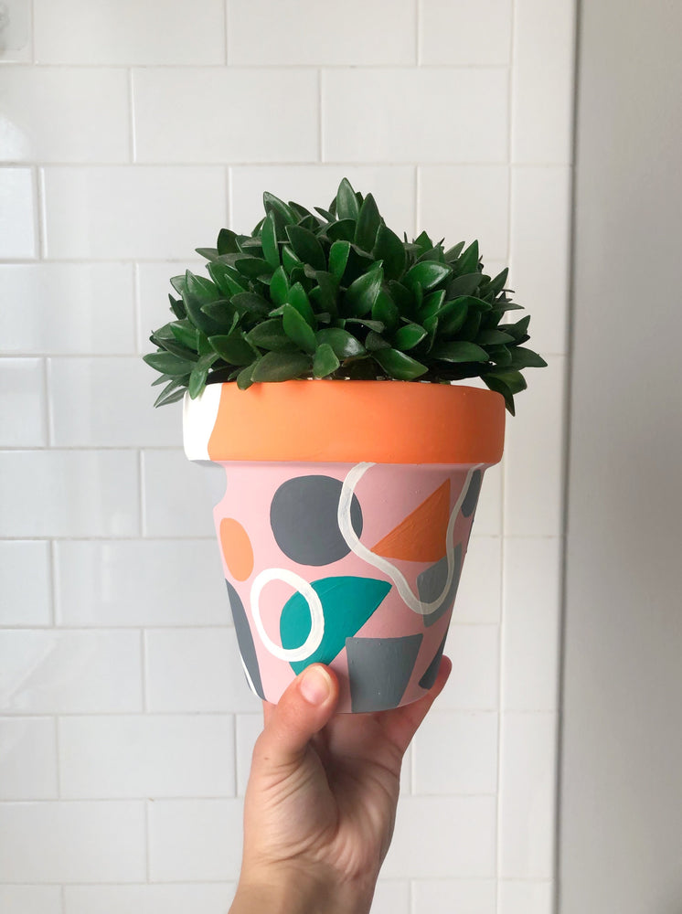 My “Orange Floral" hand painted terracotta planter combines funky shapes and floral leaves to bring some brightness to your space!