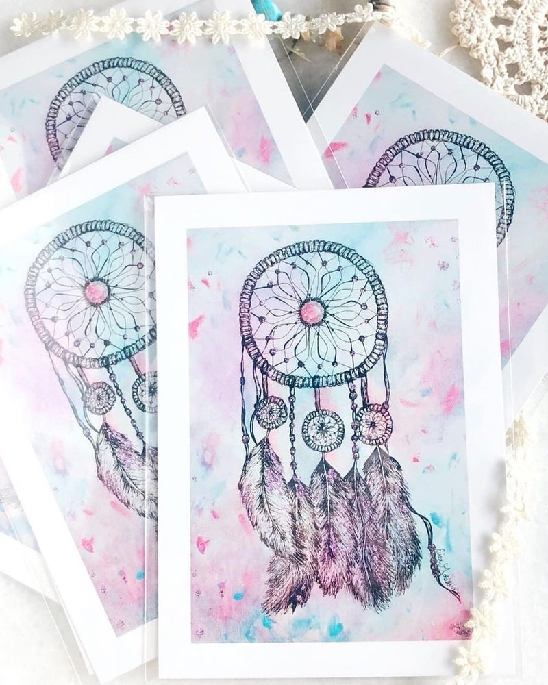 Erica Goldstein, founder of The Blank Canvas Company, creates handmade artwork - canvases, prints and greeting cards - to empower women. Her "Pastel Dreamcatcher" artwork is available as stationary or as a wall art print.