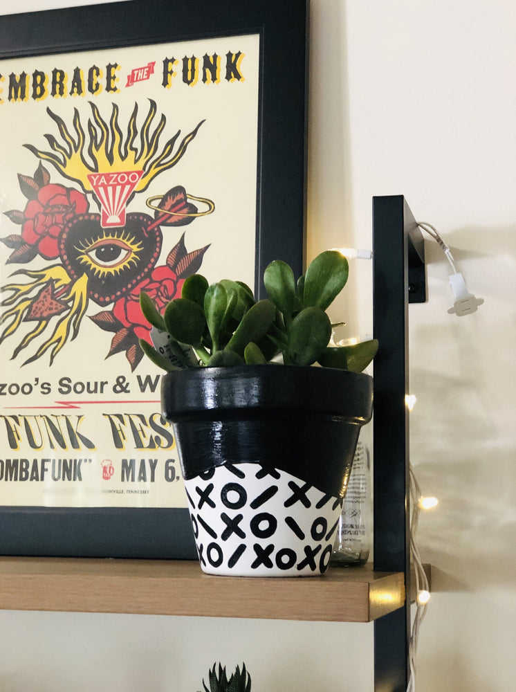 
                
                    Load image into Gallery viewer, My &amp;quot;X&amp;#39;s &amp;amp; O&amp;#39;s&amp;quot; hand painted terracotta planter is one of my all time favorites. I love the simplicity of the black and white pattern. This one is for the classy gals who like to keep it neutral!
                
            