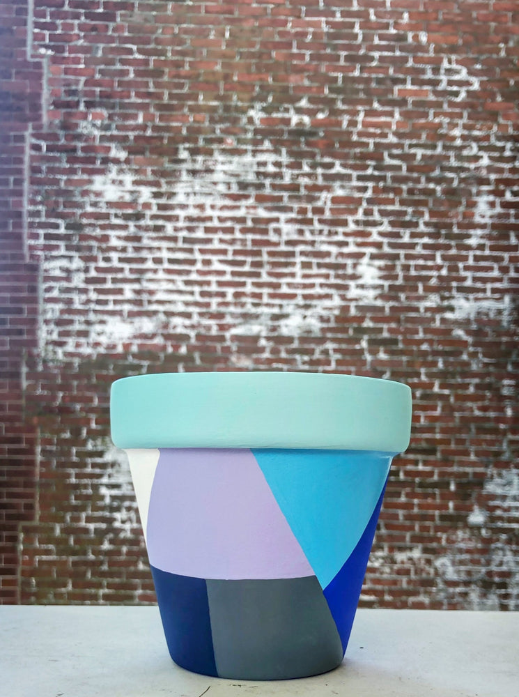 The Blank Canvas Company's hand painted "Blue & Gray Geometric" terracotta planter is a mix of modern chic + funky fresh. These cool tones will bring a sense of calm to your space.