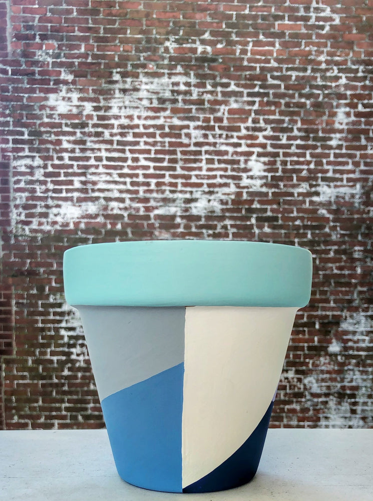 The Blank Canvas Company's hand painted "Blue & Gray Geometric" terracotta planter is a mix of modern chic + funky fresh. These cool tones will bring a sense of calm to your space.