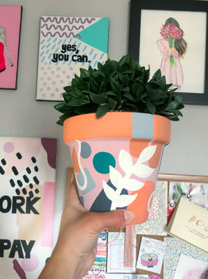 My “Orange Floral" hand painted terracotta planter combines funky shapes and floral leaves to bring some brightness to your space!